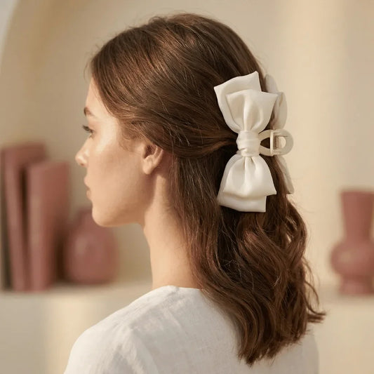 Satin bow hair clip in ivory cream worn in hair